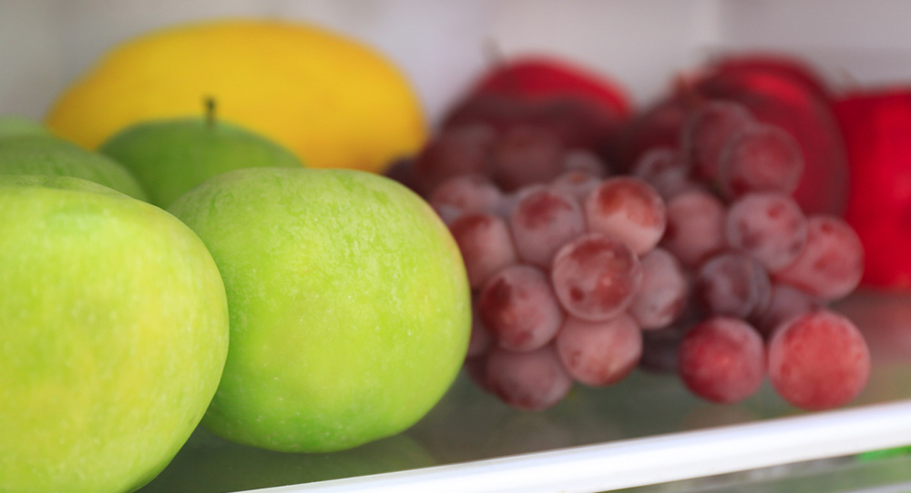 apples and other fruits in the fridge
