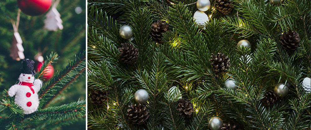 closeup of christmas tree decorated with snowman ornament, pinecones silver balls and lights